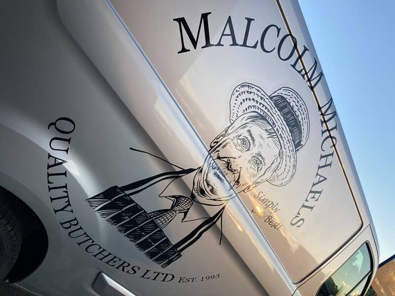 An image of the Malcolm Michaels Quality Butchers LTD van graphics on a white van.